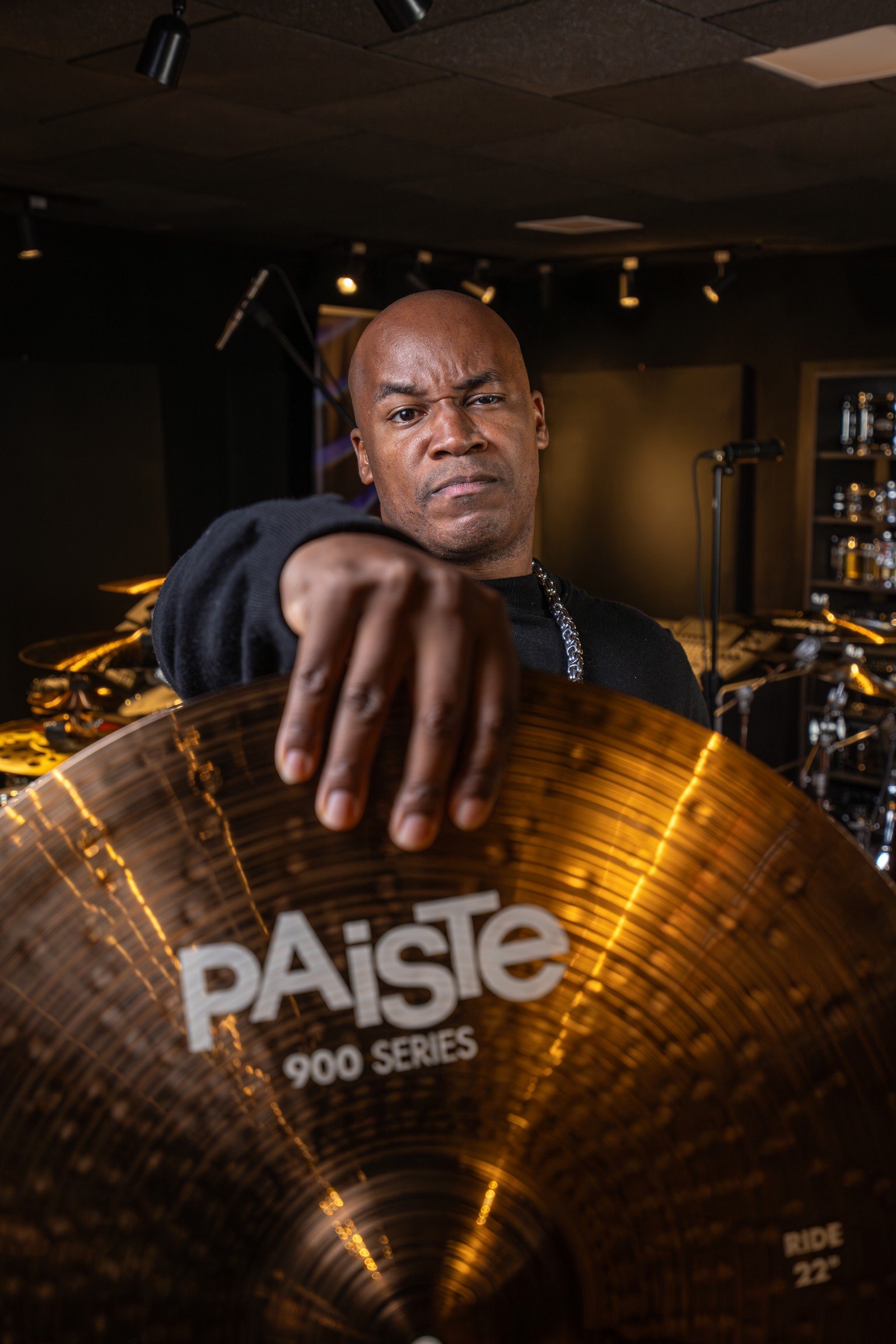 Josivaldo Santos segurando prato Paiste em seu est&uacute;dio